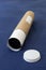 Labelled packaging tube for deliveries with end cap and rolled up paper contents