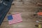 Labor Day in America, May 1. A lot of handy tools on a dark wooden background with the flag of America with copy space