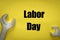 `Labor day` inscription on a yellow card with the assembly keys arranged