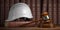 Labor law concept. Gavel  with concstruction hard hat and books