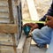 Labor man using a plumb bob for check