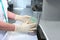 The laboratory assistant holds an open container with biological cultures in his hands. Hands in protective gloves. Clinical