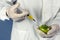 laboratory assistant injects into a green tomato with nitrates so that they are fresh, GMOs