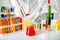 Laboratory assistant pouring liquid from test tube into flask at table