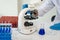 Laboratory concept: Close-up of chemicals in a laboratory, a biochemist is conducting experiments in a controlled environment