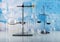 Laboratory conditions. Chemical scales, tripod with laboratory flasks and test tubes on blue