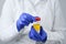 Laboratory doctor with  can of urine tests in his hands on a white background