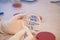 Laboratory doctor holding sterile swab and petri dish