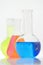 Laboratory flasks and beakers with liquids of different colors on lab table