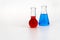 Laboratory glassware with liquid on white background. glass chemical flask with reagent