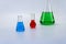 Laboratory glassware with liquid on white background. glass chemical flask with reagent