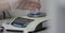 Laboratory high precision weighing scale. Young engineer using vernier height gauge. Precision scales in laboratory.