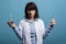 Laboratory professional chemist holding glass flasks filled with chemical liquid substances while looking at camera.