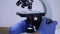 Laboratory technician makes fine-tuning of the microscope