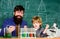 Laboratory test tubes and flasks with colored liquids father and son child at school. Chemistry beaker experiment