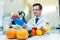 Laboratory worker examining fruits and vegetables and making analysis for pesticides and nitrates.