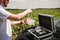 Laboratory worker testing plant sprouts before harvest in the field.