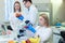 Laboratory workers examining fruits and vegetables and making analysis for pesticides and nitrates.