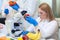 Laboratory workers examining fruits and vegetables and making analysis for pesticides and nitrates.