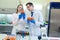 Laboratory workers examining fruits and vegetables and making analysis for pesticides and nitrates.