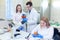 Laboratory workers examining fruits and vegetables and making analysis for pesticides and nitrates.