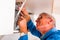 Laborer fixing the cupboard