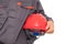 Laborer holding red hard hat in front of white background