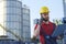 Laborer outside a factory working dressed with safety overalls