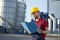 Laborer outside a factory working dressed with safety overalls equipment