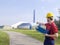 Laborer outside a factory working dressed with safety overalls equipment