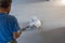 Laborer polishing sand and cement screed floor.