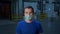 Laborer in protective mask and t-shirt in plant warehouse