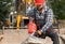 A laborer uses a jackhammer to break up a concrete pavement