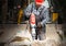A laborer uses a jackhammer to break up a concrete pavement