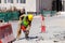 A laborer uses a jackhammer to break up a concrete pavement