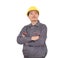 Laborer in yellow hard hat holding his arms standing in front of white background