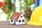 Laborer yellow hard hat and small house model