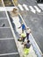 Laborers applying asphalt during the works for the pavement of a