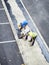 Laborers applying asphalt during the works for the pavement of a