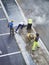 Laborers applying asphalt during the works for the pavement of a