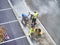 Laborers applying asphalt during the works for the pavement of a