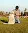 Labrador Dog and Trainer with Chew Toys in Park