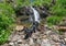 Labrador Retriever Black dog laying on the grass in the mountains