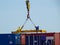 Labuan,Malaysia-Feb 26,2020:Busy crane & foreman workers unloading containers box from cargo freight ship at the port of Labuan is