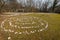 Labyrinth made of white stones on a green meadow near Beli on a sunny day in spring