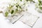 Lace with a blossoming apple tree branch on a stone surface of a table with reflections