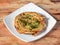 Lachha Paratha, a layered flat bread using wheat flour, popular dish in north India. isolated over a rustic wooden background,