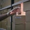 Lack of coronavirus vaccine in boxes in stock. A gloved hand steals medicines from a warehouse