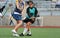 Lacrosse player checking opponent