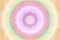 Lacy white mandala on pastel retro, yellow, purple, green, orange aura, glowing energy field - grainy gradient